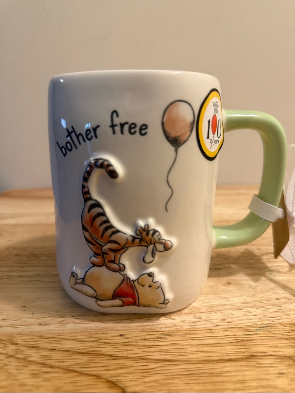 Rae Dunn White Ceramic Winnie the Pooh "bother free" Mug with Green Handle